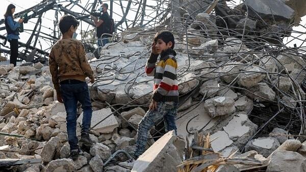 <div class="paragraphs"><p>People inspect a site of an Israeli strike, in the town of Almat</p></div>