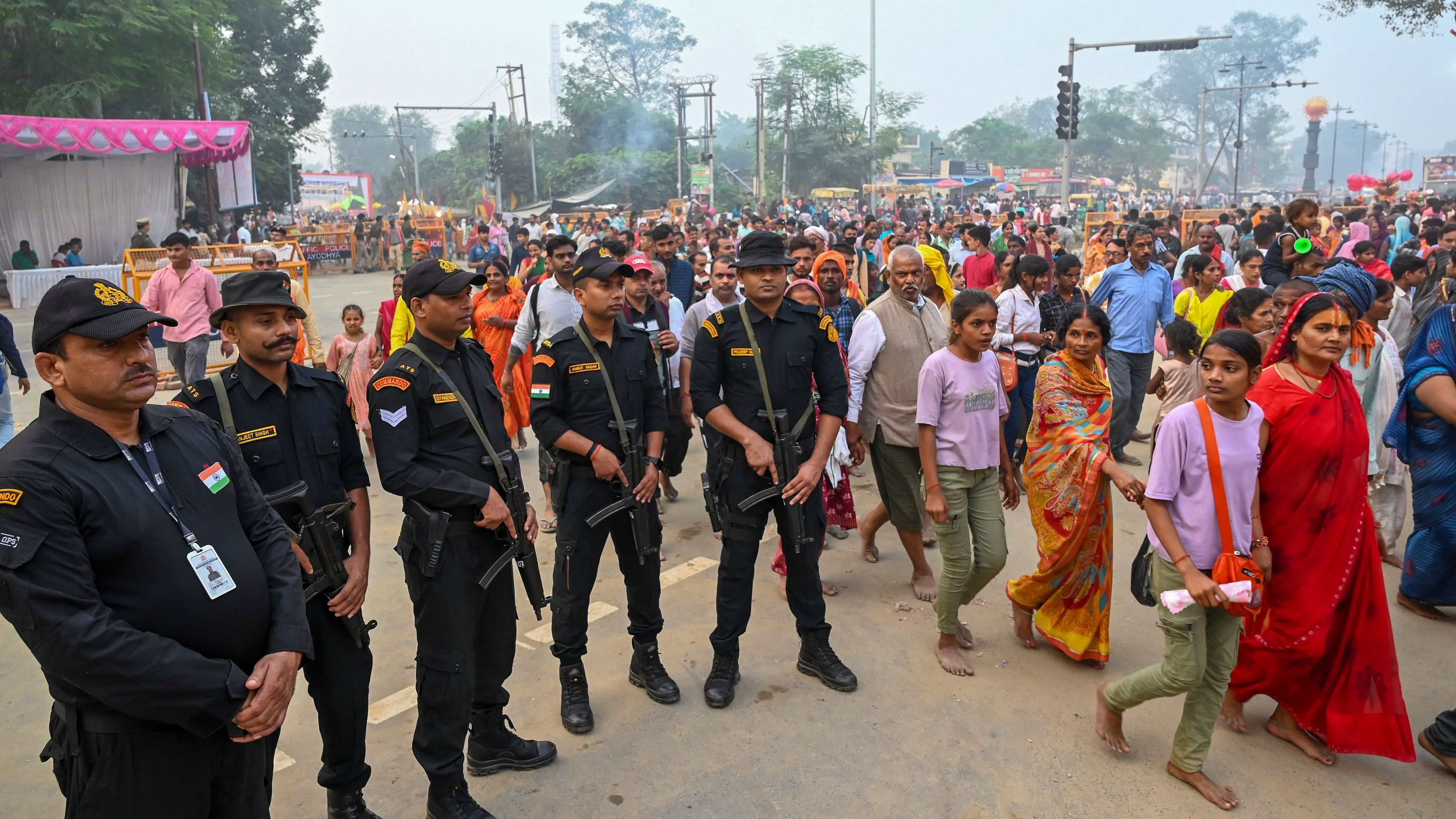 <div class="paragraphs"><p>ATS commandos stand guard as devotees perform '14 Kosi Parikrama', in Ayodhya.</p></div>