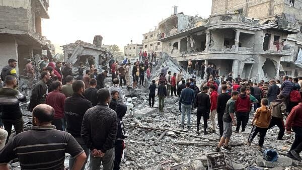 <div class="paragraphs"><p>Palestinians gather at the site of an Israeli strike on a house, in Jabalia in the northern Gaza Strip November 10, 2024.</p></div>