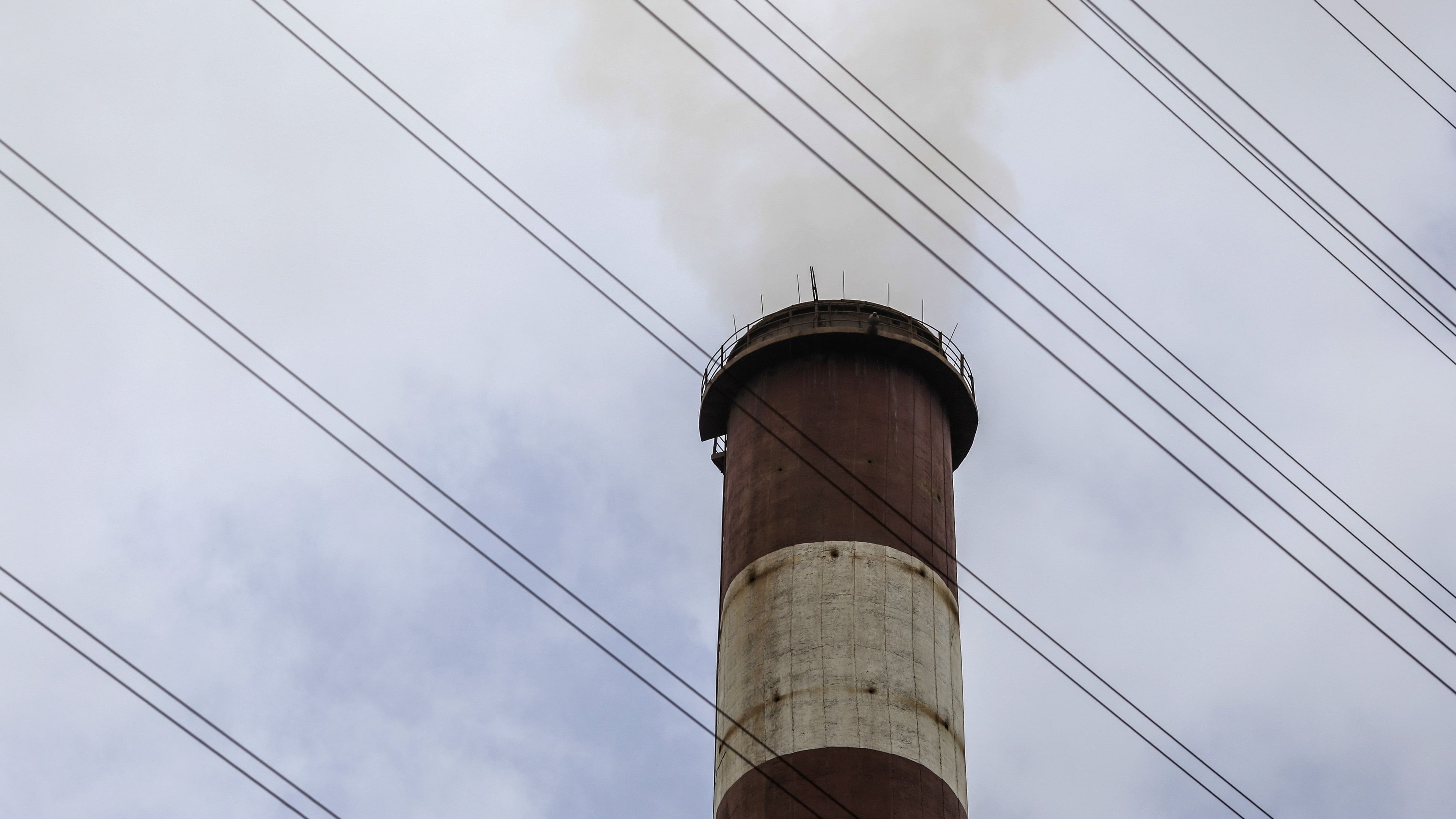 <div class="paragraphs"><p>Smoke rises from a chimney as electricity pylons stand at a thermal power station in India.</p></div>