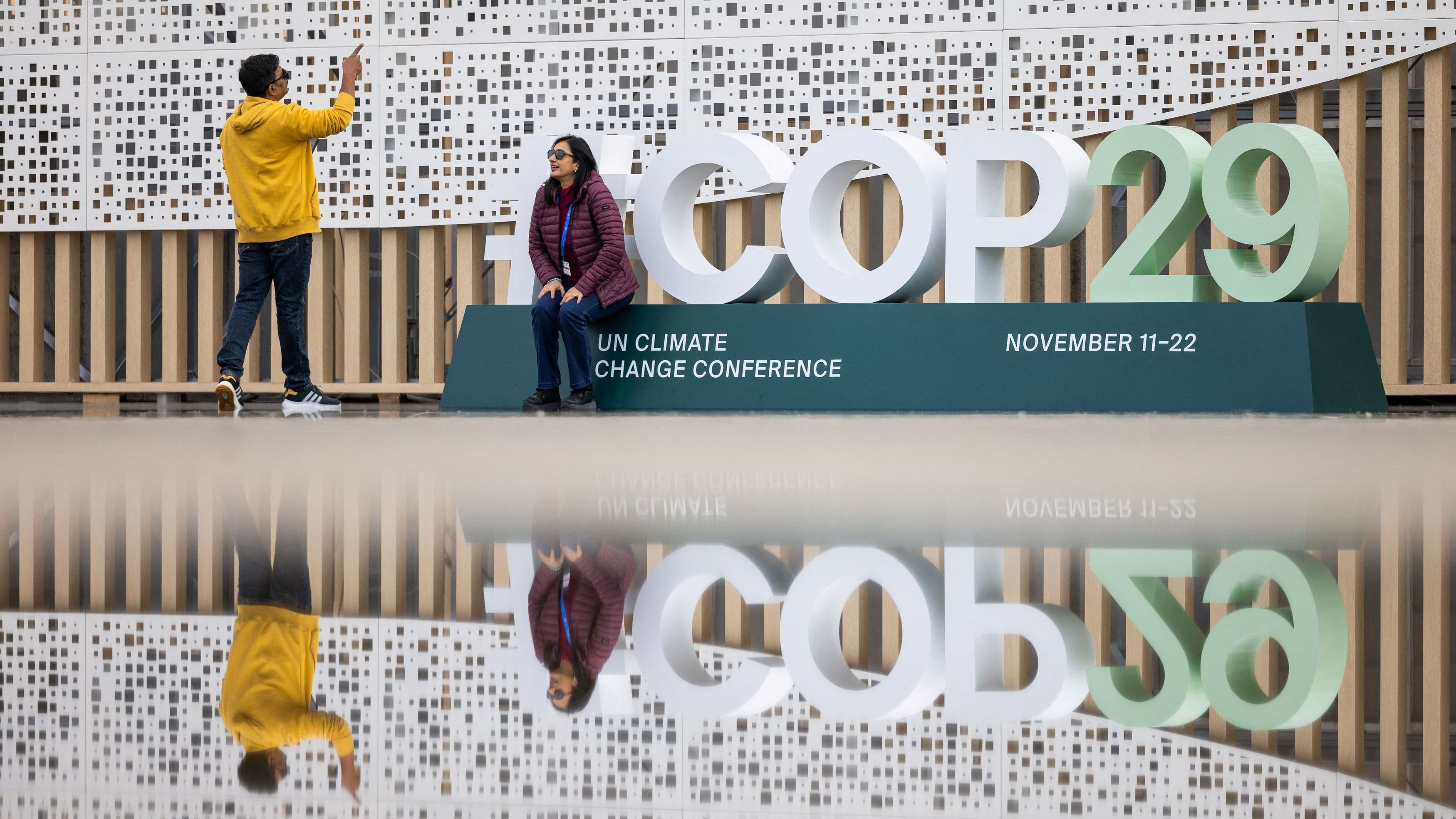 <div class="paragraphs"><p>People take photos near the entrance to the venue of the United Nations climate change conference, known as COP29, ahead of the summit beginning in Baku, Azerbaijan November 10, 2024.</p></div>