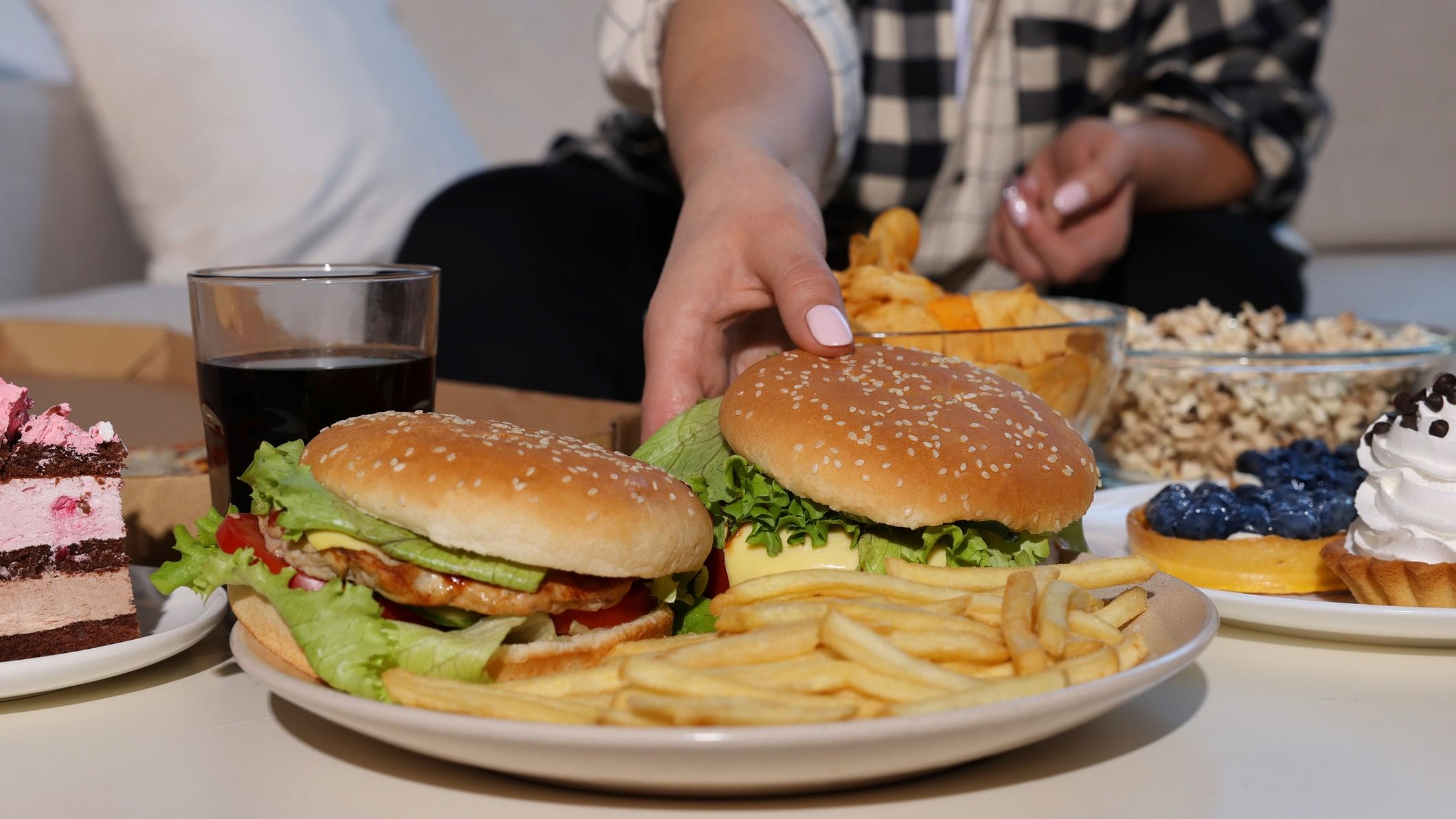 <div class="paragraphs"><p>Image showing a person gorging on fast food. For representational purposes.</p></div>