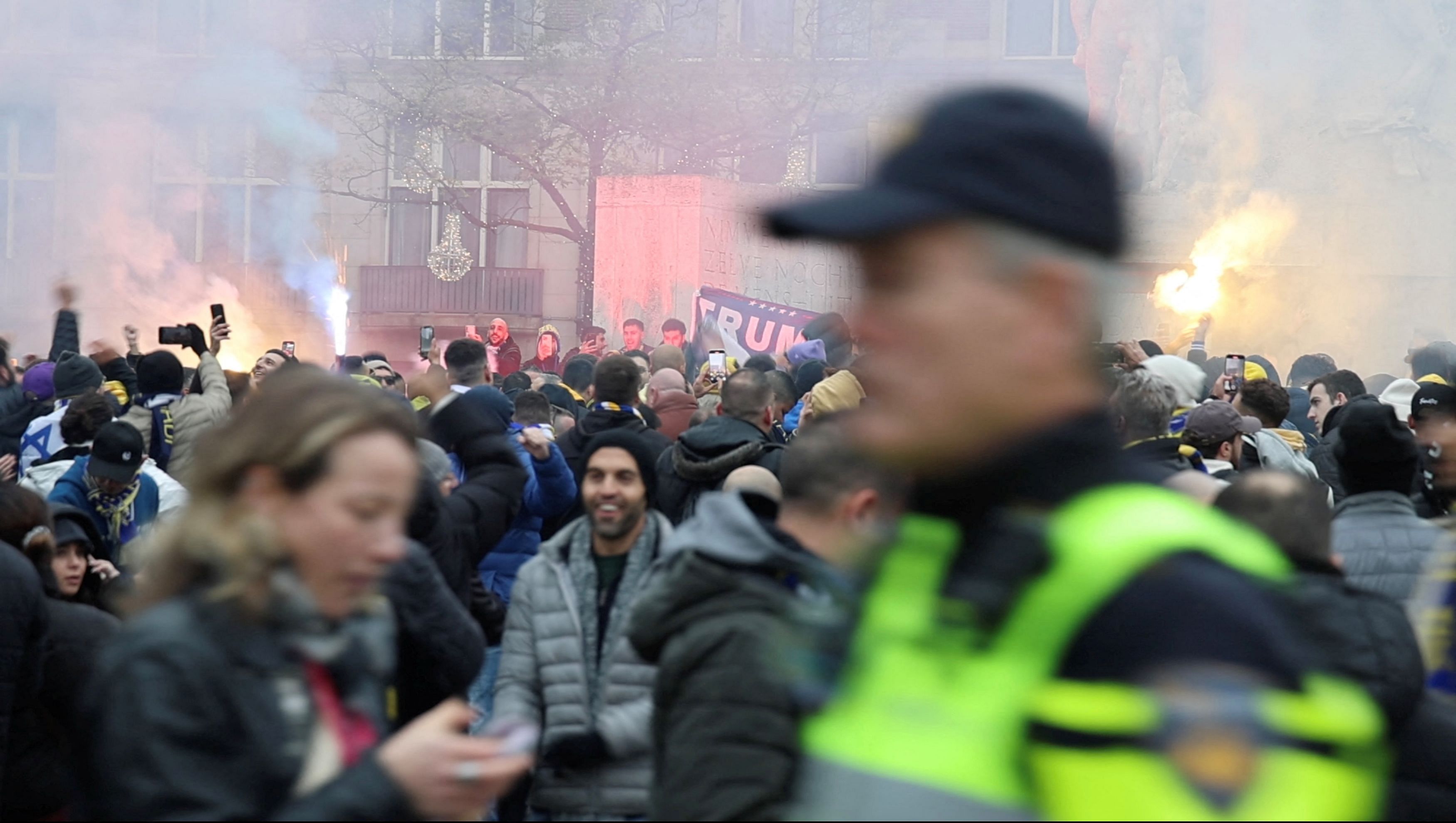 <div class="paragraphs"><p>Israeli Maccabi Tel Aviv supporters demonstrate and light flares as a policeman patrols the area in Amsterdam, Netherlands, November 7, 2024, in this screengrab obtained from a social media video.</p></div>