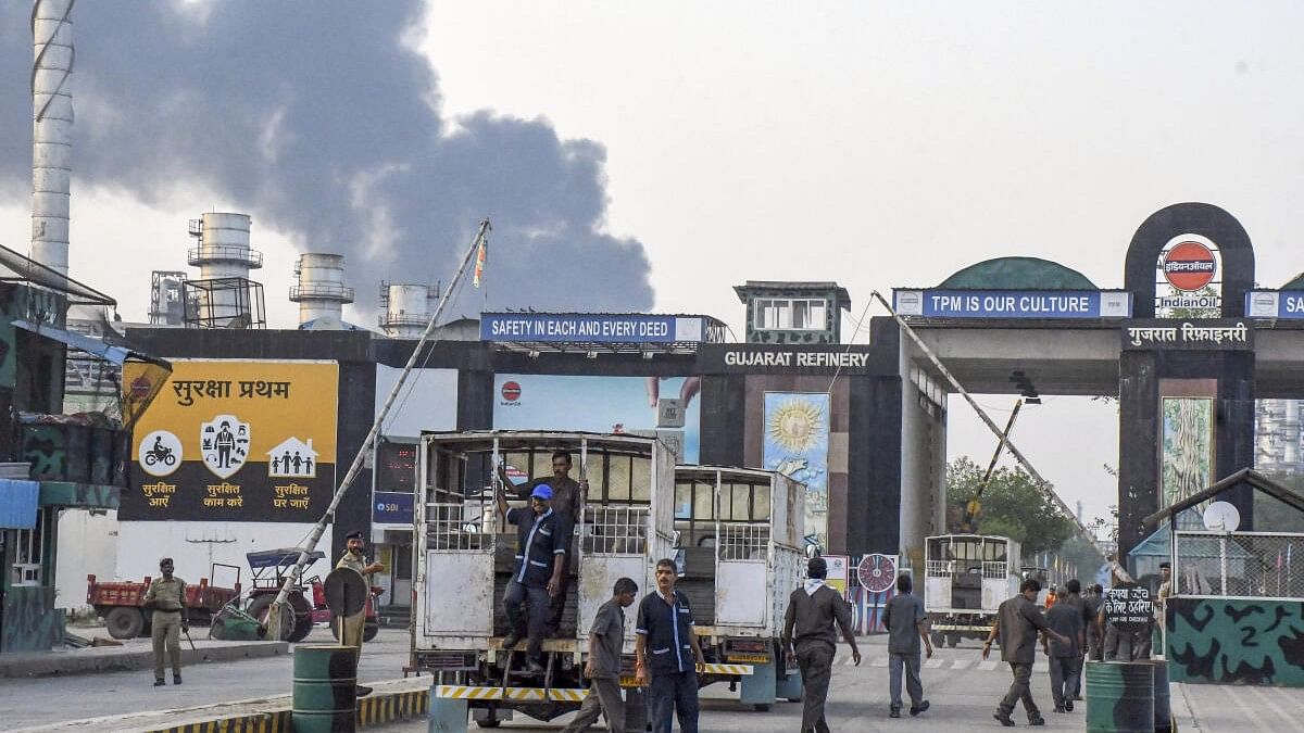 <div class="paragraphs"><p>Workers wait outside after an explosion at a refinery of Indian Oil Corporation, in Vadodara, Monday, Nov. 11, 2024.</p></div>