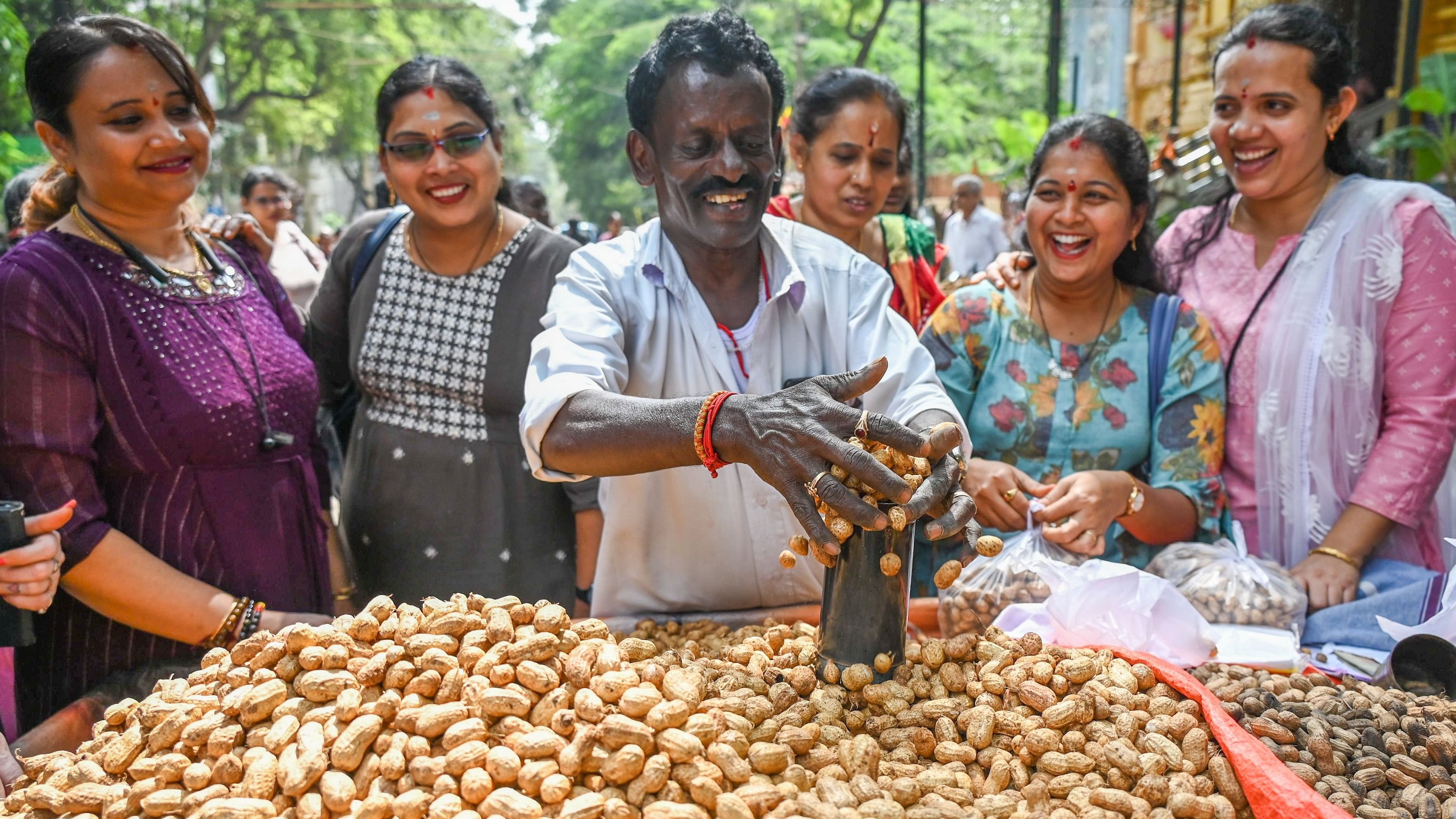 <div class="paragraphs"><p>A groundnut vendor with his produce in front of the Kadu Malleshwara temple.</p></div>