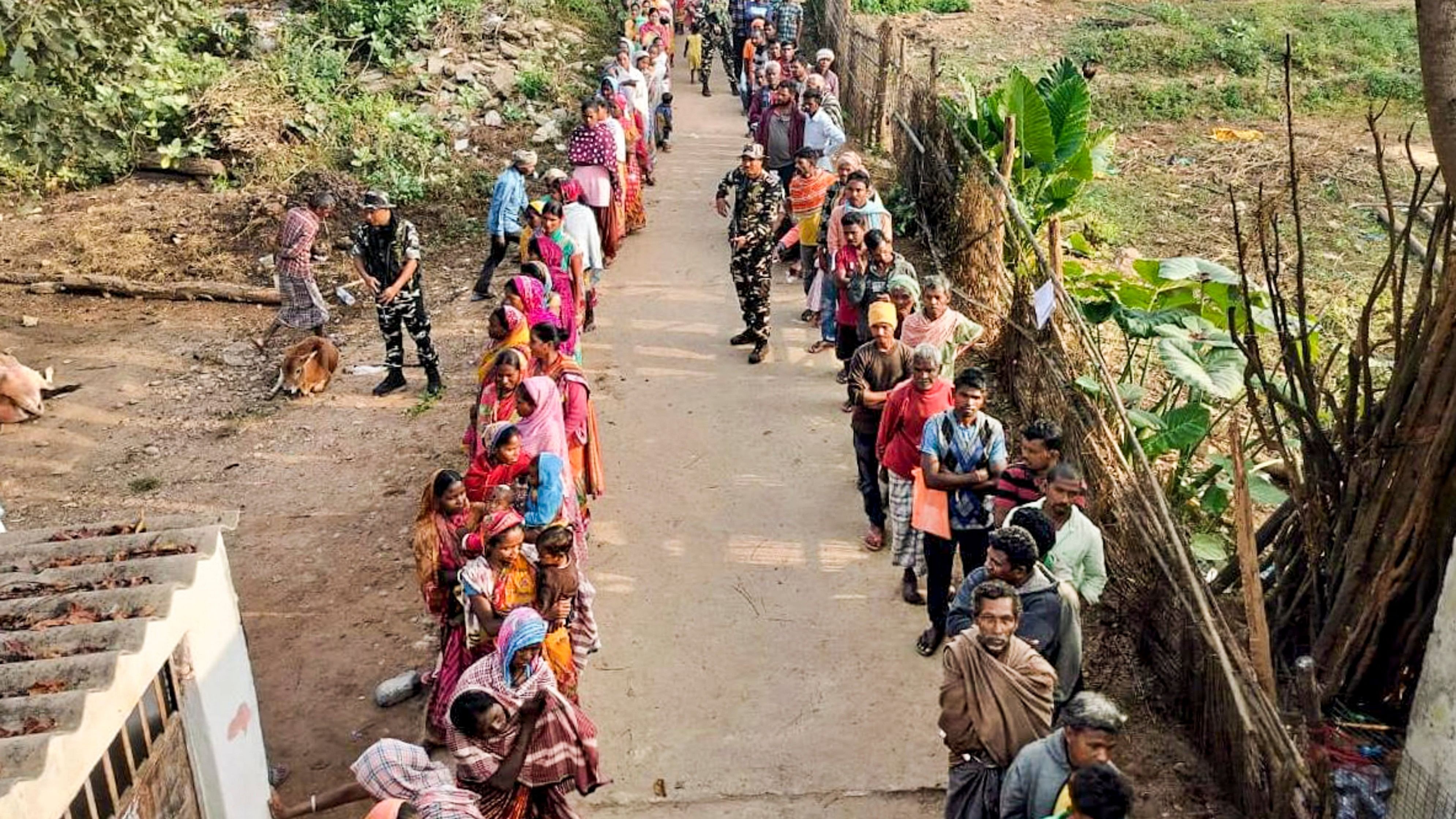 <div class="paragraphs"><p>People wait in queues to cast their votes at a polling booth in a Naxal-affected area during the first phase of Jharkhand Assembly elections, in Seraikela Kharsawan district, Wednesday, Nov. 13, 2024.</p></div>