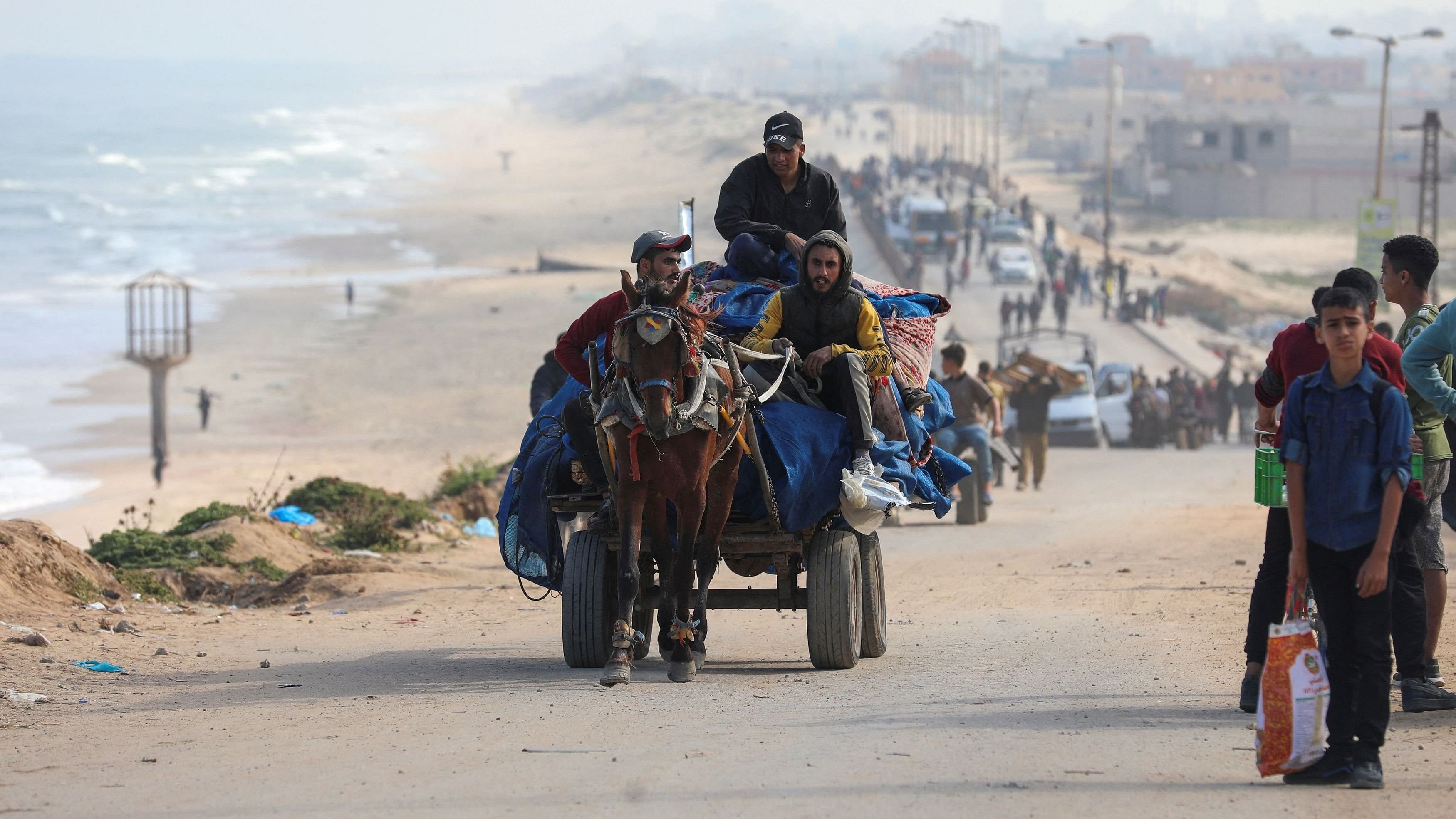 <div class="paragraphs"><p>People ride a horse-drawn cart as Palestinians, who were displaced by Israel's military offensive on south Gaza, make their way attempting to return to their homes in north Gaza through an Israeli checkpoint, amid the ongoing conflict between Israel and Hamas.</p></div>