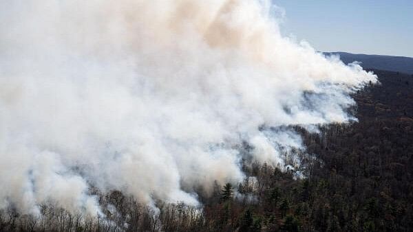 <div class="paragraphs"><p>Smoke rises from the Jennings Creek Wildfire impacting Passaic County, NJ and Orange County, NY near Jennings Creek, New Jersey, US.</p></div>