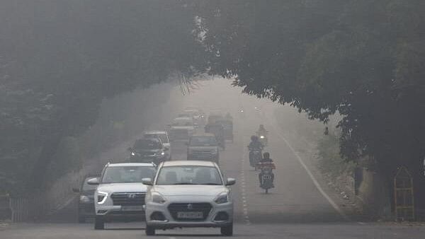 <div class="paragraphs"><p>Traffic passes by on a road as the sky is enveloped with smog after Delhi's air quality was classified as "hazardous" amidst severe air pollution, in New Delhi</p></div>