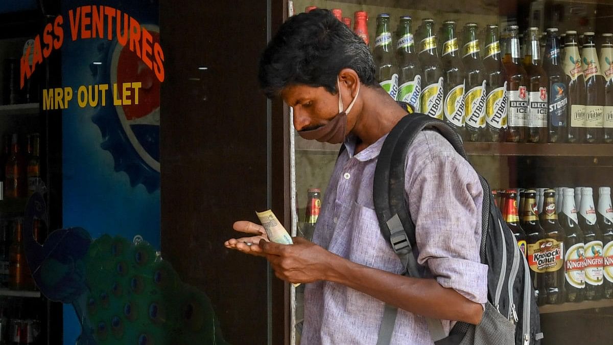 <div class="paragraphs"><p>A customer stands in queue to buy liquor. </p></div>