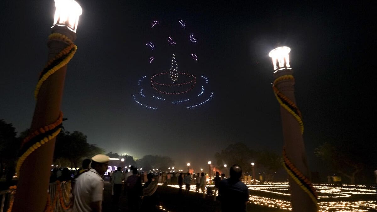 <div class="paragraphs"><p> Illuminated lamps and drone show at Vasudev Ghat on the banks of the Yamuna river as part of 'Dilli Deepotsav', ahead of Dev Deepawali, in New Delhi, Wednesday, Nov. 13, 2024. Over 3.5 lakh earthen lamps are being lit at the ghat.</p></div>