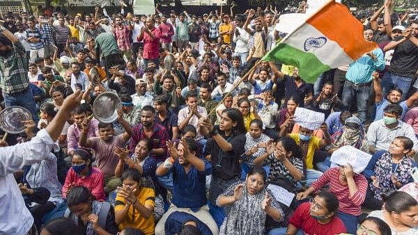 <div class="paragraphs"><p>Aspirants stage a protest against UPPSC, demanding the implementation of 'Single Day, Single Sheet' exams, in Prayagraj.</p></div>