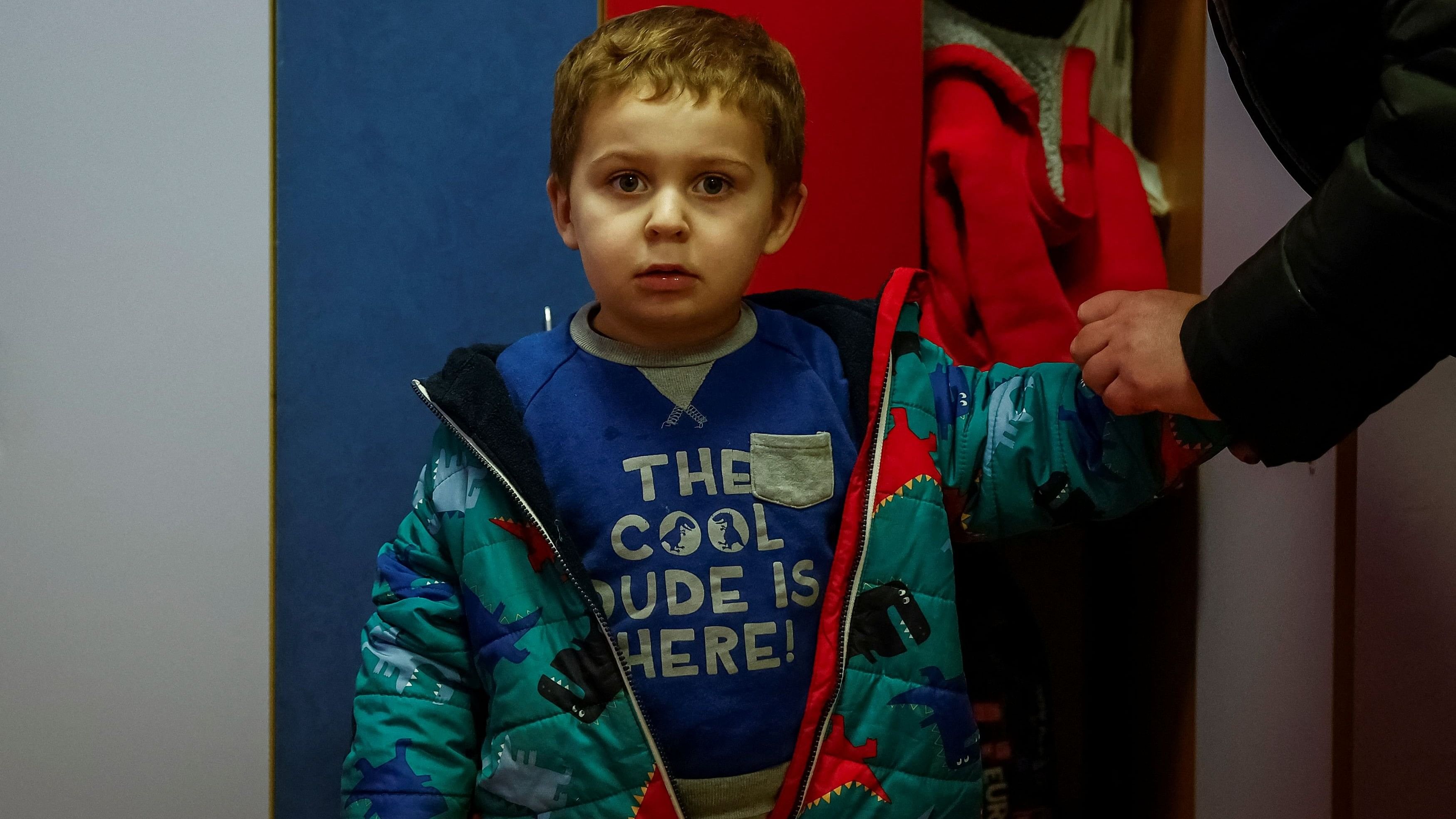 <div class="paragraphs"><p>Yevhen Stepanenko, 2-years-old, stands in a kindergarden, while his mother Liudmyla Rodchenko, 42-years-old, dresses him up before going home, amid Russia's attack on Ukraine, in the town of Bucha in Kyiv region, Ukraine.</p></div>