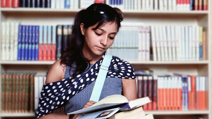 <div class="paragraphs"><p>Representative image of a female student reading a book in the library campus.</p></div>