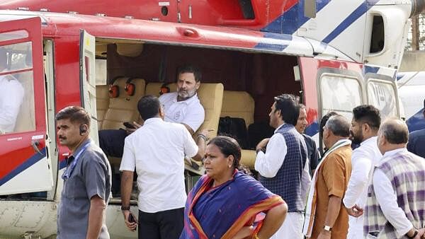 <div class="paragraphs"><p>Rahul Gandhi waits as his helicopter was reportedly delayed due to a clearance issue from the Air Traffic Control in Jharkhand's Godda on Friday.</p></div>