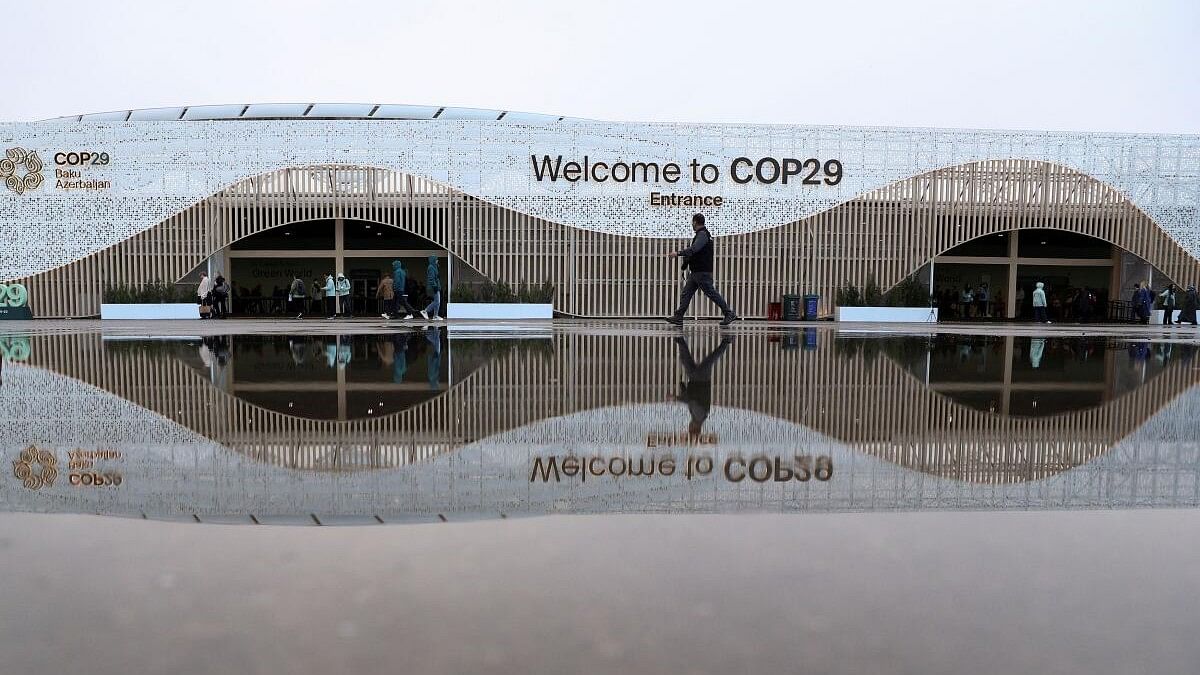 <div class="paragraphs"><p>People walk in front of the venue of the United Nations climate change conference COP29, in Baku, Azerbaijan </p></div>