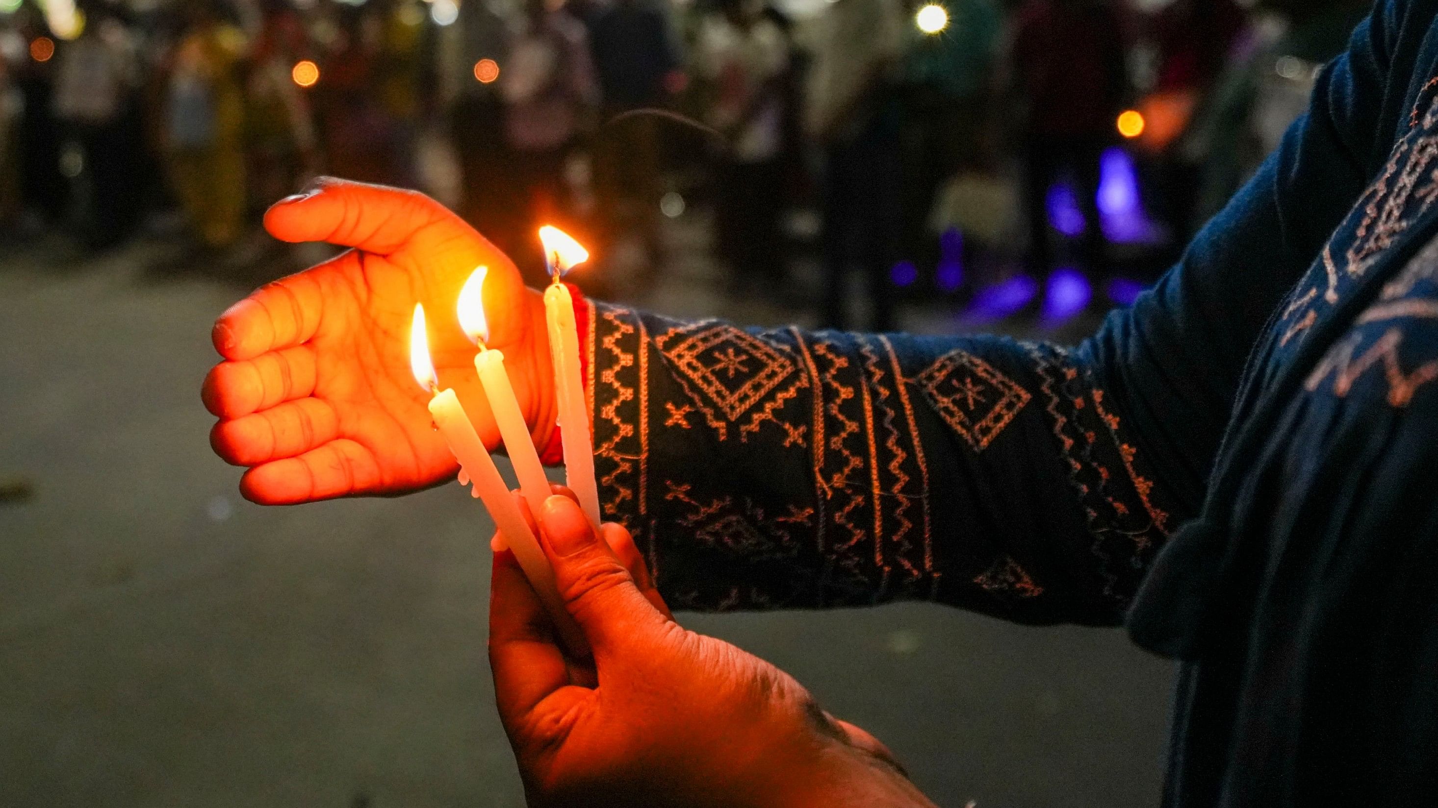 <div class="paragraphs"><p>A protestor holds candles during a candlelight vigil. Representative image.</p></div>