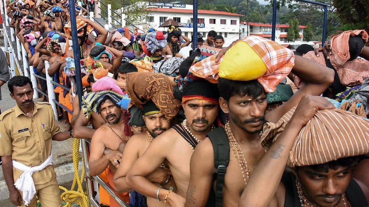 <div class="paragraphs"><p>Devotees queue up to offer prayers at Lord Ayyappa temple during the Malayalam month of 'Vrischikom,' in Sabarimala. </p></div>