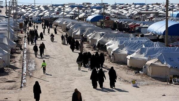 <div class="paragraphs"><p>Women walk through al-Hol displacement camp in Hasaka governorate, Syria.&nbsp;</p></div>