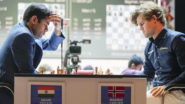 <div class="paragraphs"><p>Indian grandmaster Arjun Erigaisi, left, plays against five-time World Chess Champion Magnus Carlsen of Norway during the Tata Steel Chess India Blitz 2024, in Kolkata, Saturday.</p></div>