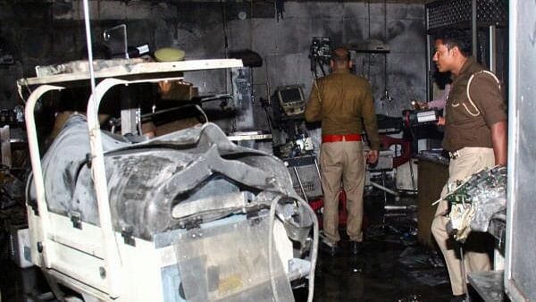 <div class="paragraphs"><p>Police officers examine the damaged neonatal intensive care unit after a fire broke out at the Maharani Laxmibai Medical College in Jhansi district, in the northern state of Uttar Pradesh, India.&nbsp;</p></div>