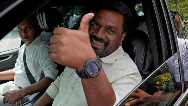 <div class="paragraphs"><p>Sri Lanka's President and National People's Power (NPP) party leader Anura Kumara Dissanayake gestures as he leaves after casting his vote on the day of the parliamentary election in Colombo, Sri Lanka.</p></div>