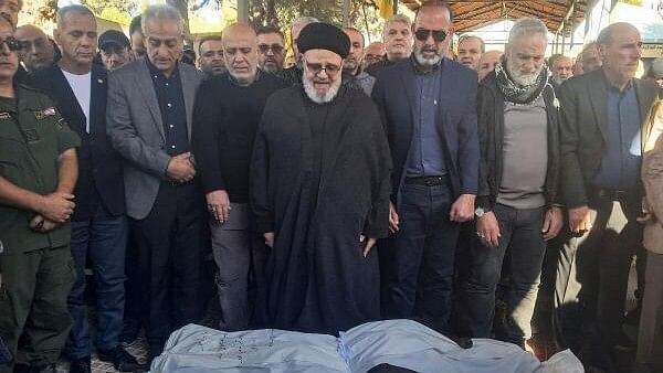 <div class="paragraphs"><p>Mourners pray near the bodies of three civil defence members who were killed during an Israeli strike that hit a civil defence centre in Baalbek on Thursday, during their funeral, amid the ongoing hostilities between Hezbollah and Israeli forces, Lebanon November 16, 2024.</p></div>