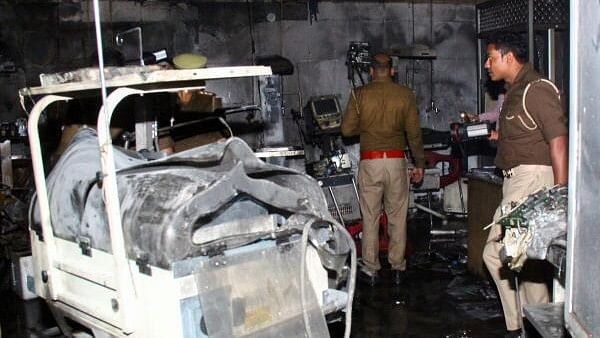 <div class="paragraphs"><p>Police officers examine the damaged neonatal intensive care unit after a fire broke out at the Maharani Laxmibai Medical College in Jhansi district, in the northern state of Uttar Pradesh, India.&nbsp;</p></div>