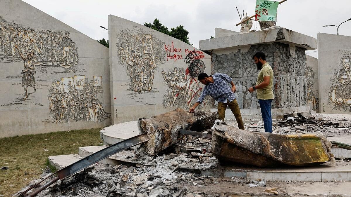 <div class="paragraphs"><p>People visit the site of a vandalised statue of Sheikh Mujibur Rahman, father of the Bangladeshi nation, after the resignation of Prime Minister Sheikh Hasina, in Dhaka.</p></div>