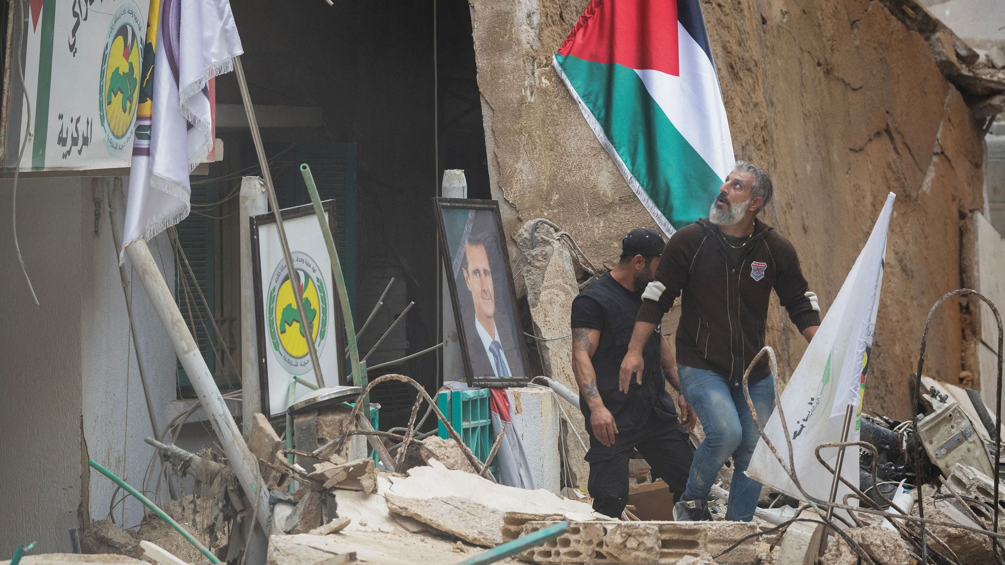 <div class="paragraphs"><p>People stand on the rubble after an Israeli strike on a building that according to security sources killed Hezbollah's media relations chief Mohammad Afif in Ras Al- Nabaa, in Beirut, Lebanon November 17, 2024. </p></div>