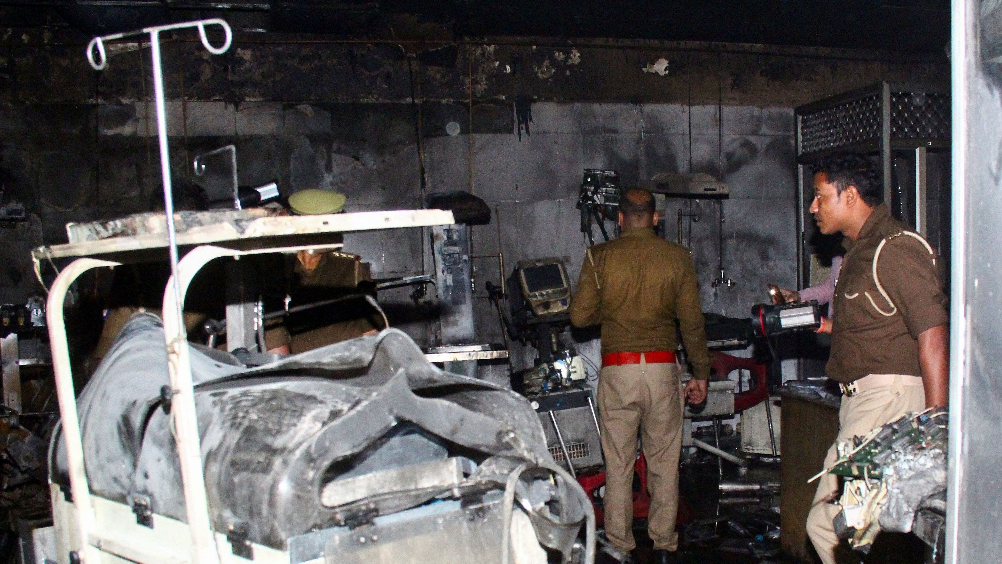 <div class="paragraphs"><p>Police officers examine the damaged neonatal intensive care unit after a fire broke out at the Maharani Laxmibai Medical College in Jhansi district, in Uttar Pradesh, November 16, 2024.</p></div>