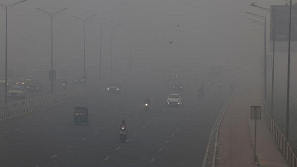 <div class="paragraphs"><p>Traffic passes on a road as the sky is enveloped with smog after Delhi's air quality turned "severe" due to alarming air pollution, in New Delhi</p></div>