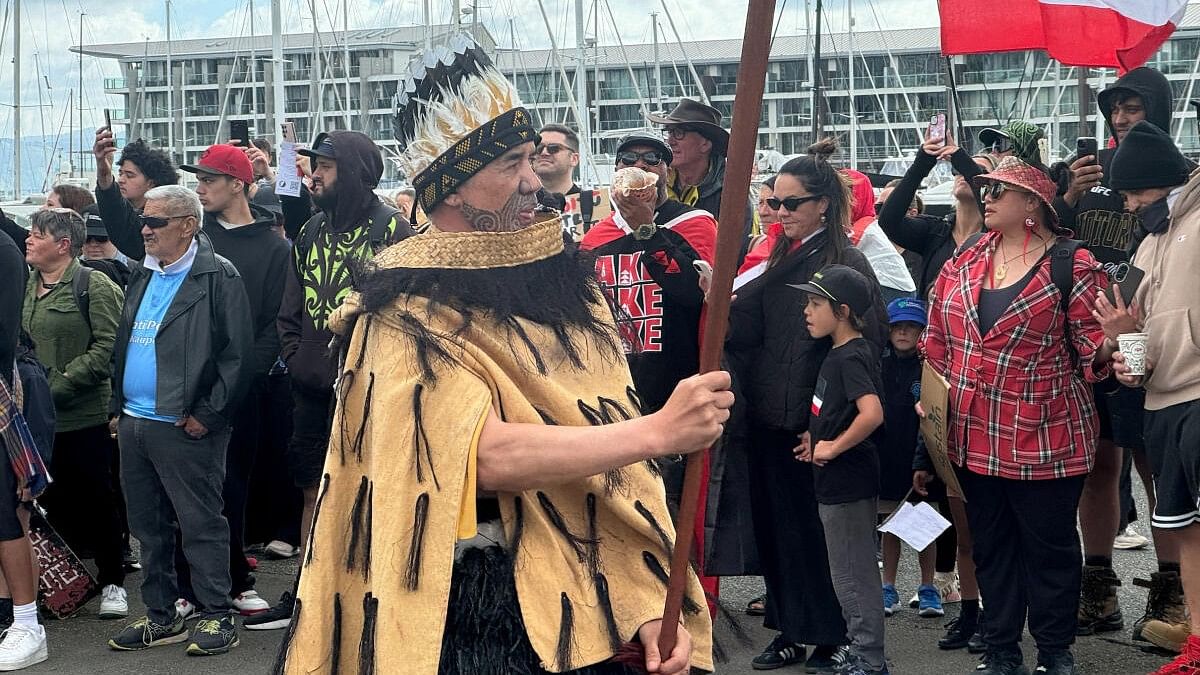 <div class="paragraphs"><p>People gather ahead of a march to the parliament in protest of the Treaty Principles Bill, in Wellington, New Zealand.</p></div>