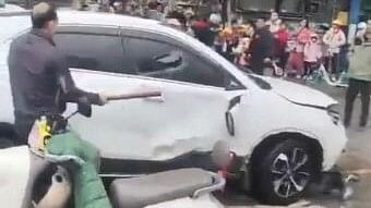 <div class="paragraphs"><p>A man breaks a car's window following a vehicle collision outside a primary school in Changde, Hunan province, China.</p></div>