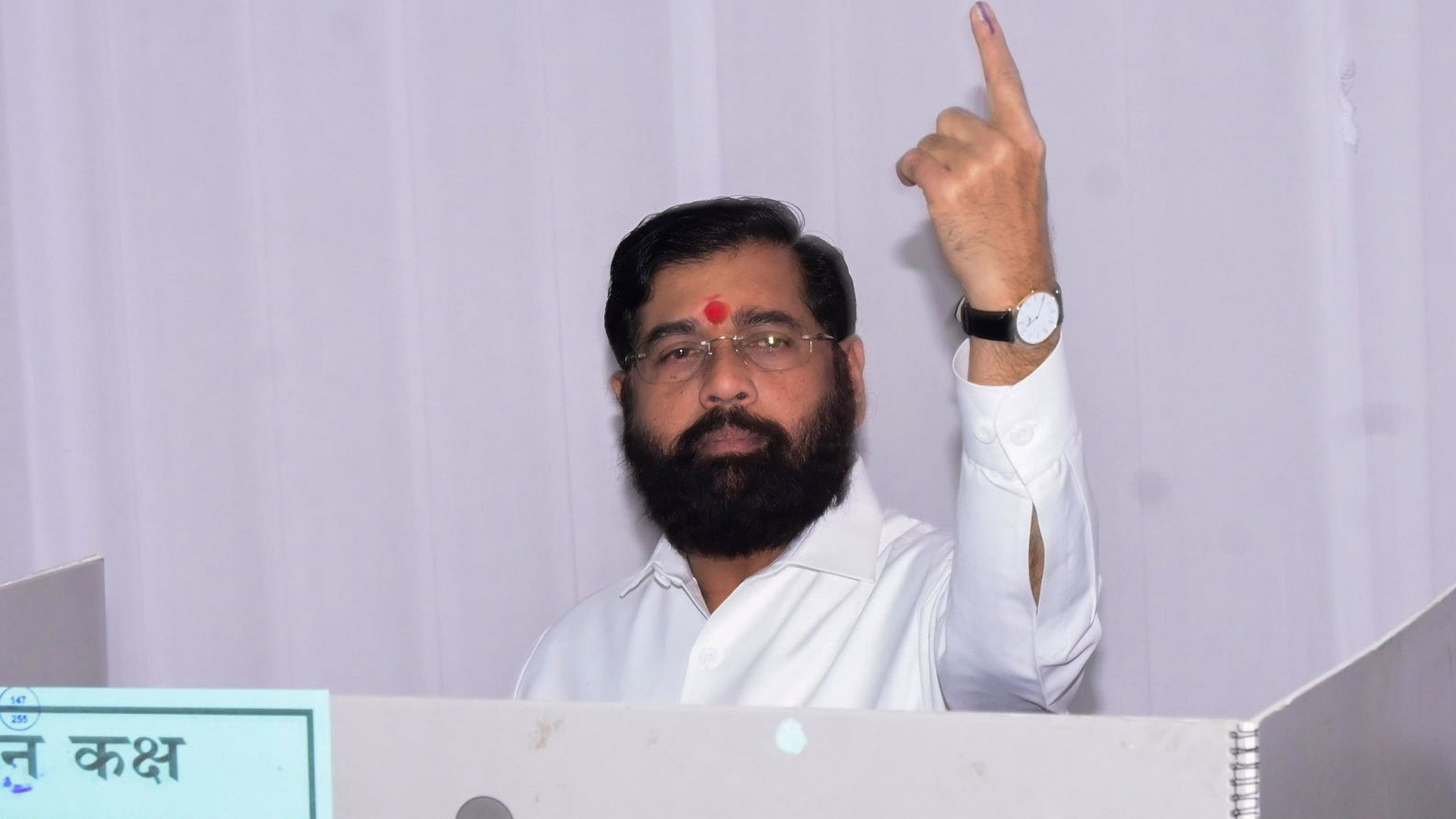 <div class="paragraphs"><p>Maharashtra Chief Minister Eknath Shinde shows his ink-marked finger after casting vote during the state Assembly elections, in Thane.</p></div>