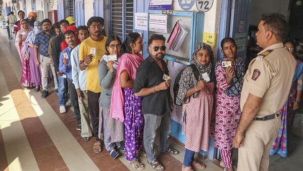 <div class="paragraphs"><p>People wait in a queue to cast votes at a polling station in Maharashtra.</p></div>