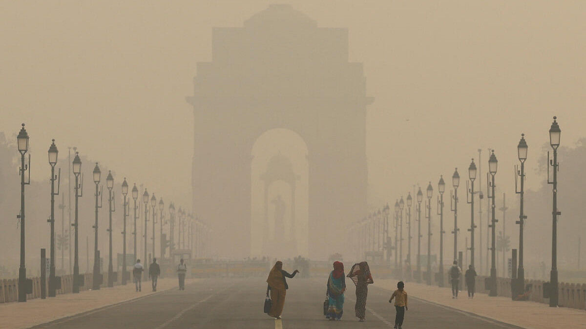 <div class="paragraphs"><p>Women walk on a road near India Gate as the sky is enveloped with smog after Delhi's air quality worsened due to air pollution, in New Delhi, India, November 19, 2024.</p></div>