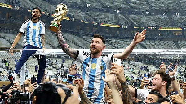 <div class="paragraphs"><p>Argentina's Lionel Messi celebrates with the trophy after winning the World Cup.</p><p></p></div>