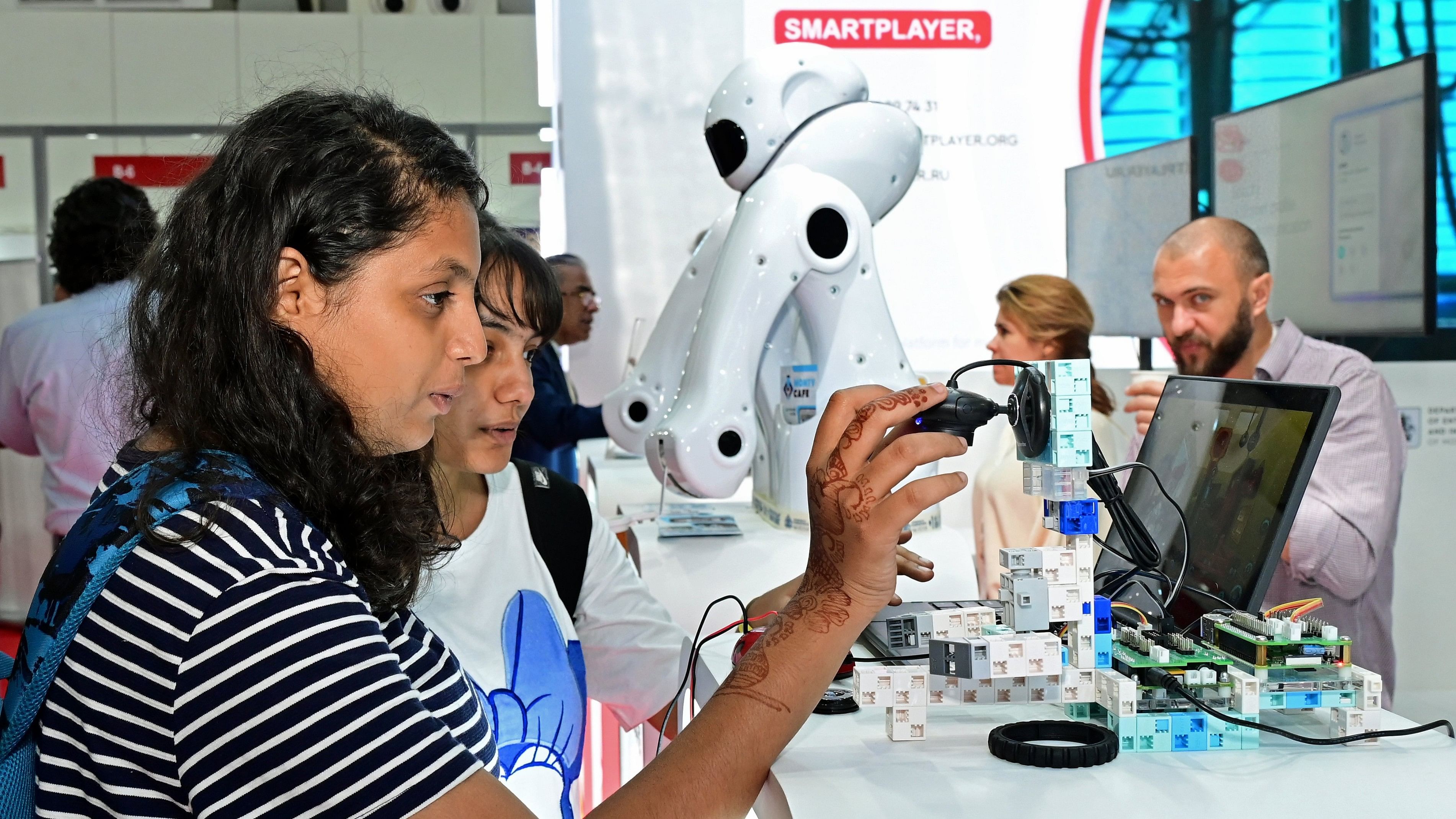 <div class="paragraphs"><p>Visitors look at exhibits at the exhibition organised as part of the Bengaluru Tech Summit at Palace Grounds on Wednesday. </p></div>