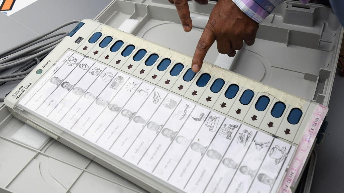 <div class="paragraphs"><p>An Indian election official examines an Electronic Voting Machine (EVM). Image for representational purposes.</p></div>