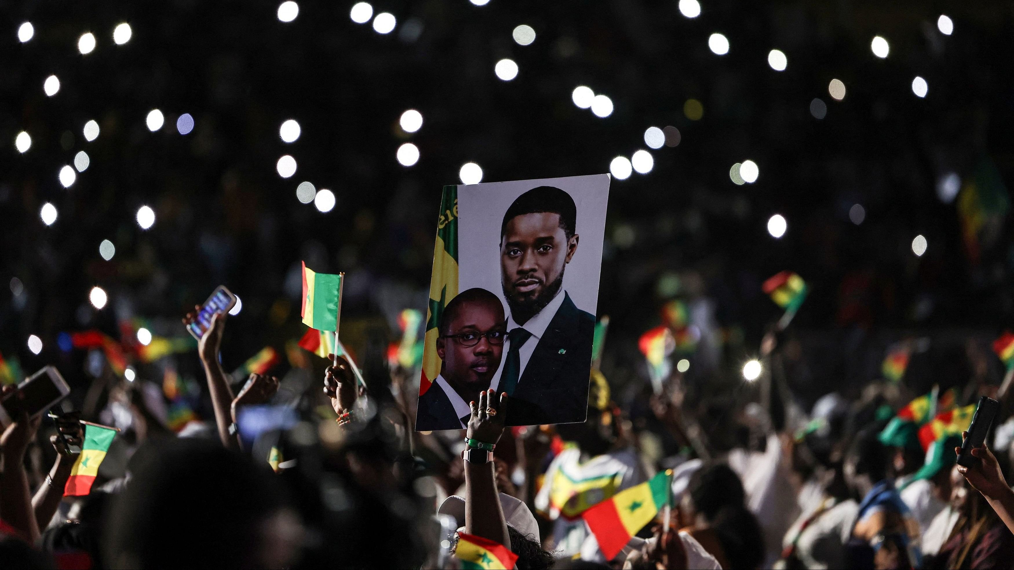 <div class="paragraphs"><p>A supporter holds a campaign poster depicting Senegal's President Bassirou Diomaye Faye and Prime Minister and the head of the ruling Pastef party, Ousmane Sonko, during Sonko's campaign rally for the upcoming early legislative election, in Guediawaye on the outskirts of Dakar, Senegal, November 13, 2024. </p></div>