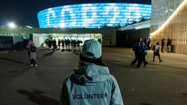 <div class="paragraphs"><p>A volunteer stands next to the COP29 United Nations climate change conference venue, in Baku, Azerbaijan, November 20, 2024. </p></div>