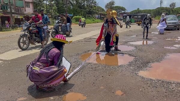 <div class="paragraphs"><p>Artists dressed as 'Yama' and 'Chitragupt' draw attention to the road's condition to aware people and highlight the urgent need for road repairs and a response from authorities, in Udupi. </p></div>