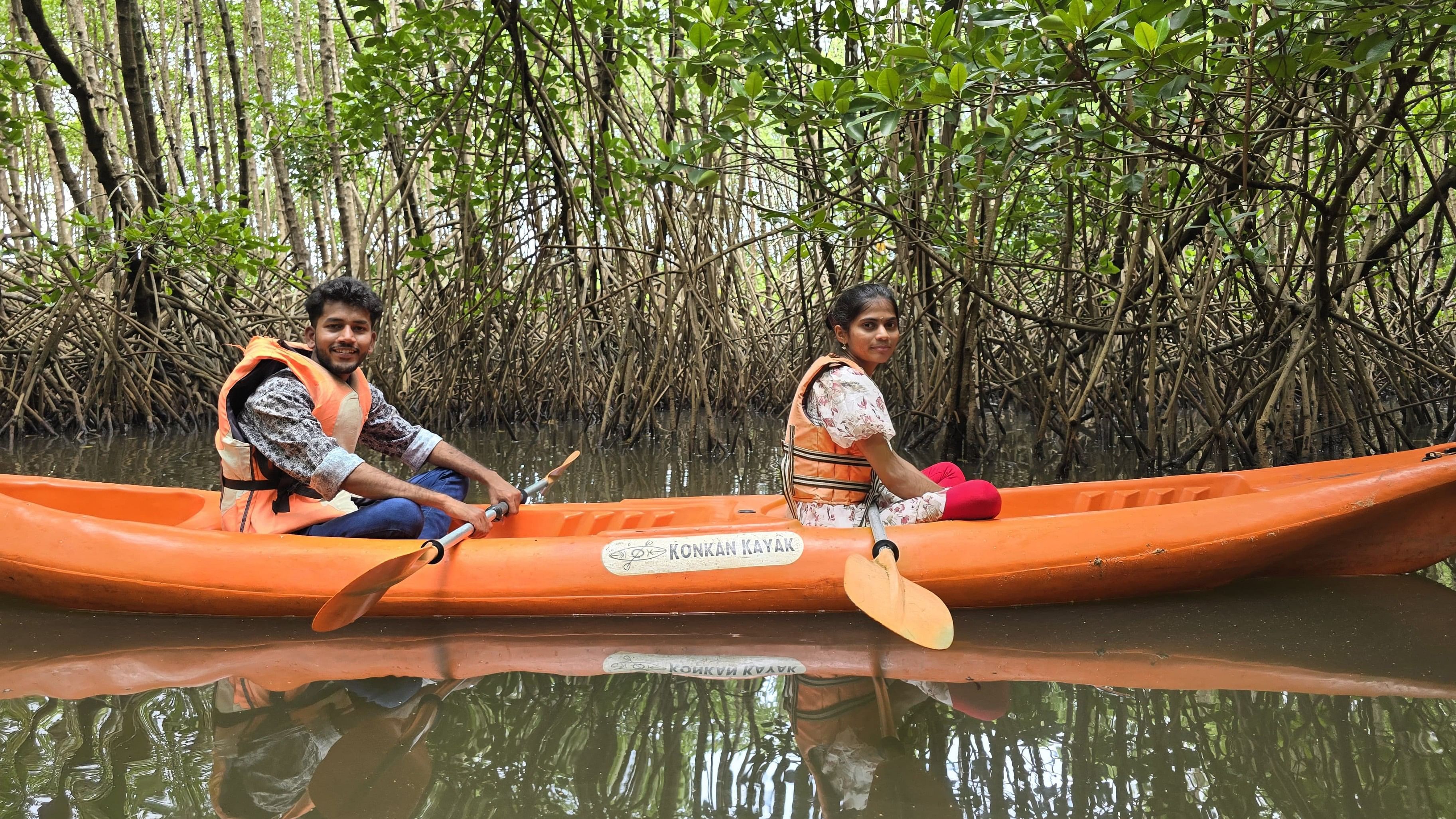 Tourists kayak through the thick mangroves.