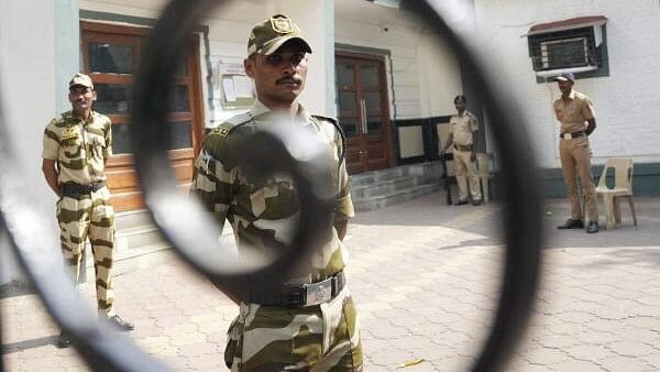 <div class="paragraphs"><p>Security personnel stand guard outside a strong room ahead of the counting of votes for the Maharashtra Assembly elections, in Mumbai, Thursday, Nov. 21, 2024.</p></div>