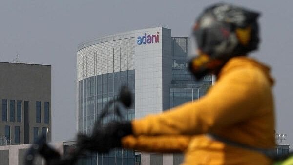 <div class="paragraphs"><p>A man rides his motorbike past the Corporate House of Adani Group on the outskirts of Ahmedabad, India, November 21, 2024.</p></div>