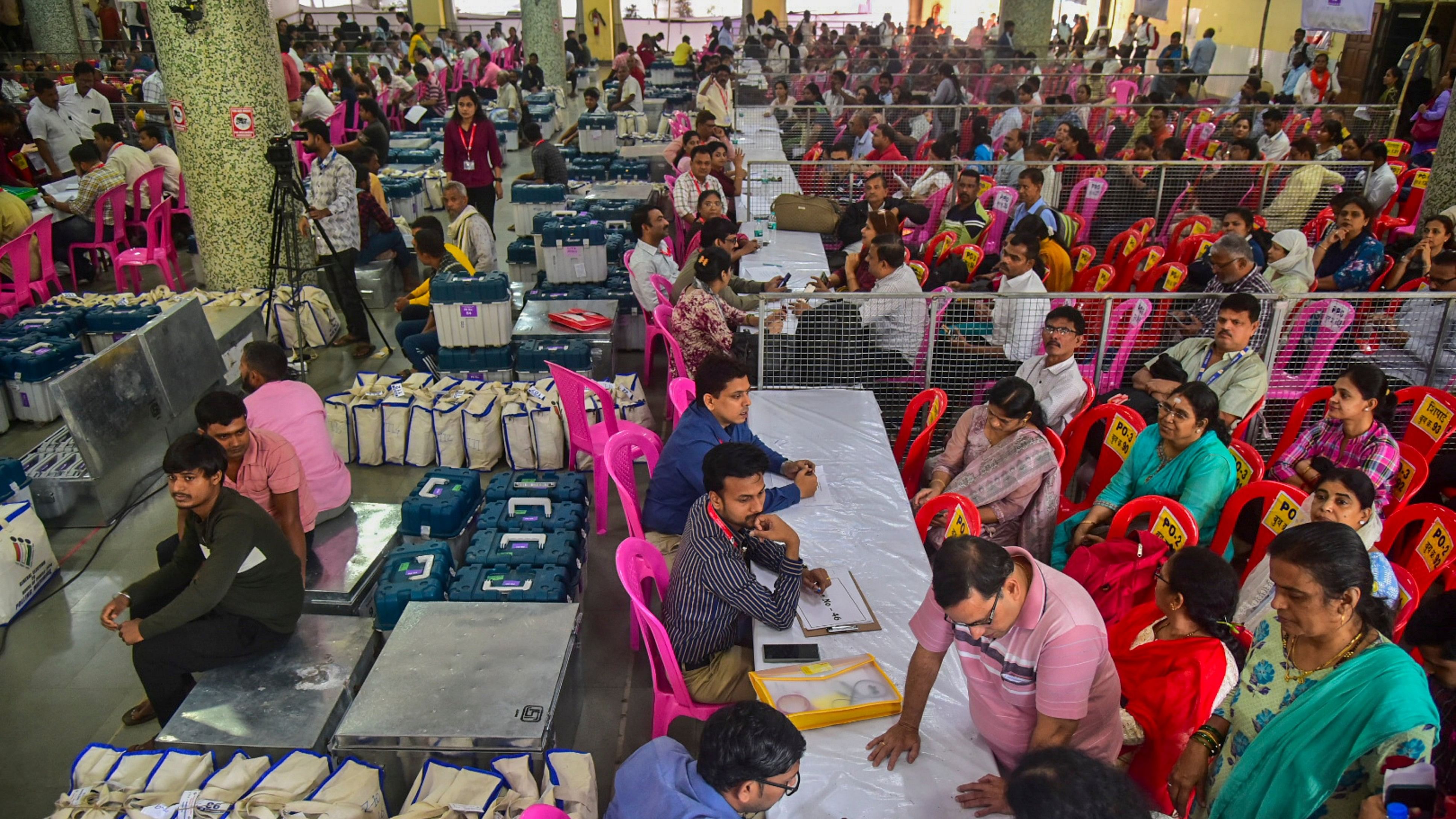 <div class="paragraphs"><p>Polling officials collect EVMs and other election material at a distribution center on the eve of voting for the Maharashtra Assembly polls, in Navi Mumbai, Maharashtra, Tuesday, Nov. 19, 2024. </p></div>