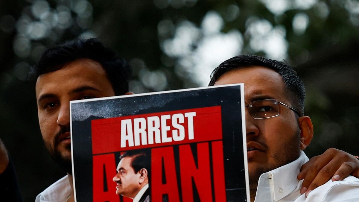 <div class="paragraphs"><p>Congress party workers hold placards during a protest against Indian billionaire Gautam Adani in Delhi, after he was indicted by a court in US.&nbsp;</p></div>