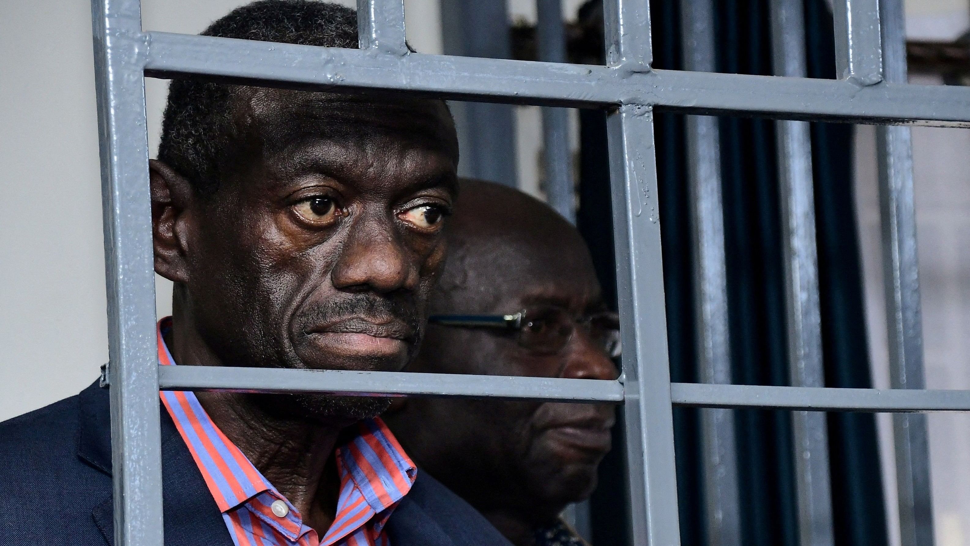 <div class="paragraphs"><p>Ugandan four-time presidential aspirant Kizza Besigye and his colleague Obeid Lutale stand in the steel dock at the Uganda Military General Court Martial in Makindye suburb of Kampala.</p></div>