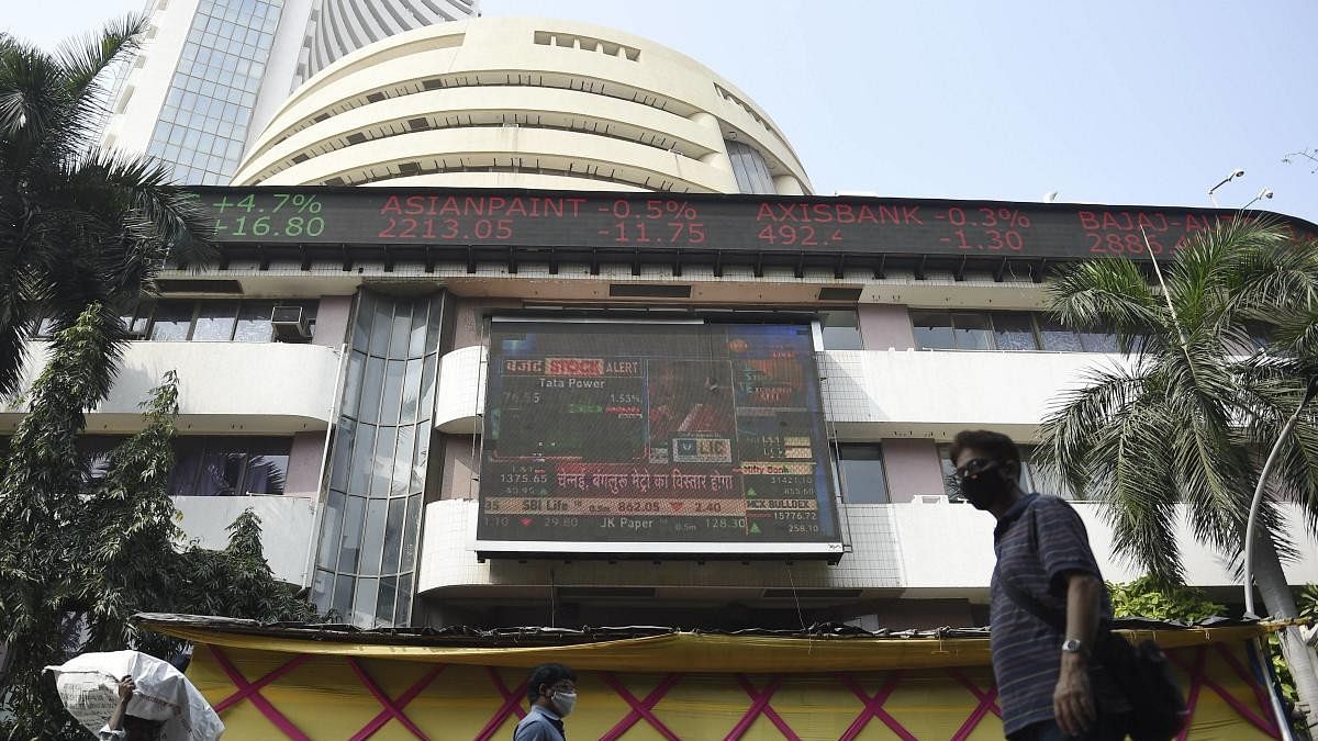 <div class="paragraphs"><p> People walk past a digital screen, displaying stock prices, on the facade of Bombay Stock Exchange (BSE), in Mumbai, Monday, Feb. 1, 2021. The BSE benchmark Sensex zoomed over 1,700 points and the NSE Nifty reclaimed the 14,000-level driven by gains in financial stocks, following the budget speech.</p></div>